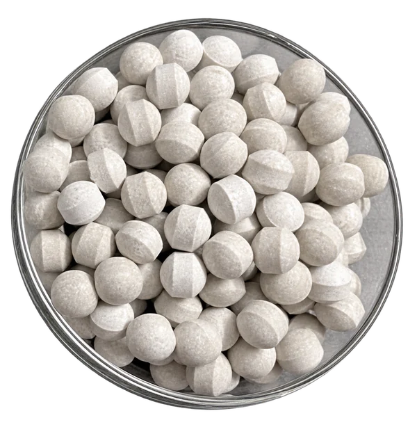 White 21-7-14 NPK fertilizer tablets in a clear dish